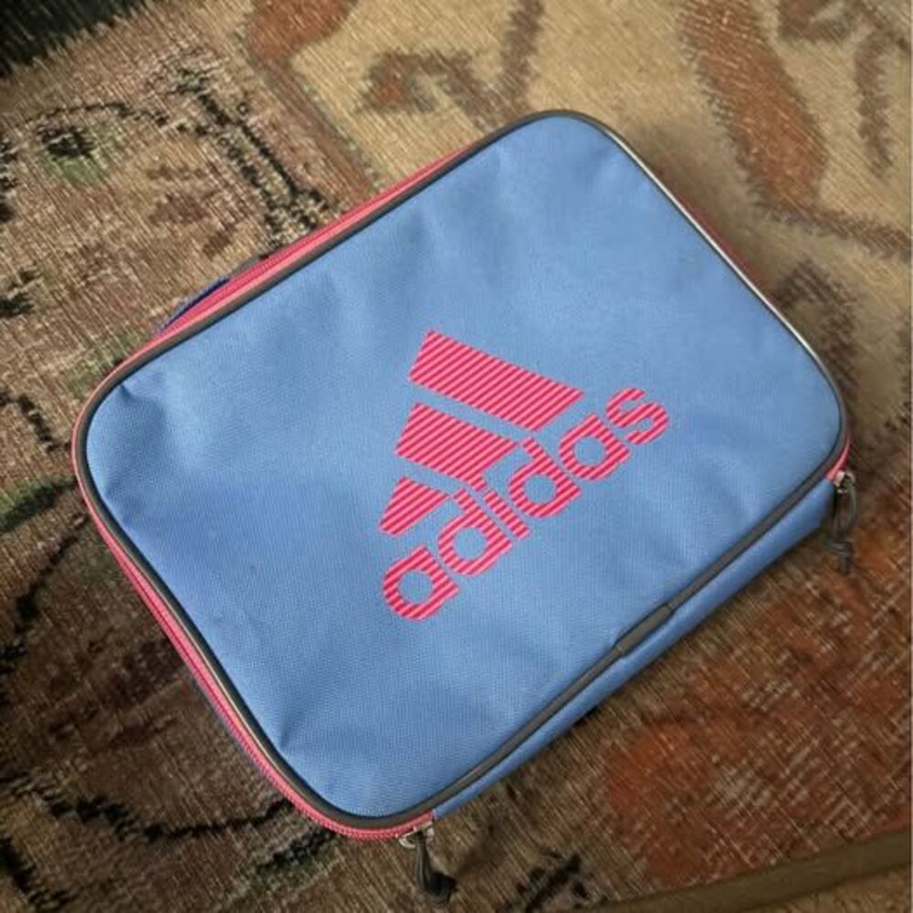 adidas Foundation Lunch Bag in a light blue colorway with a pink striped logo